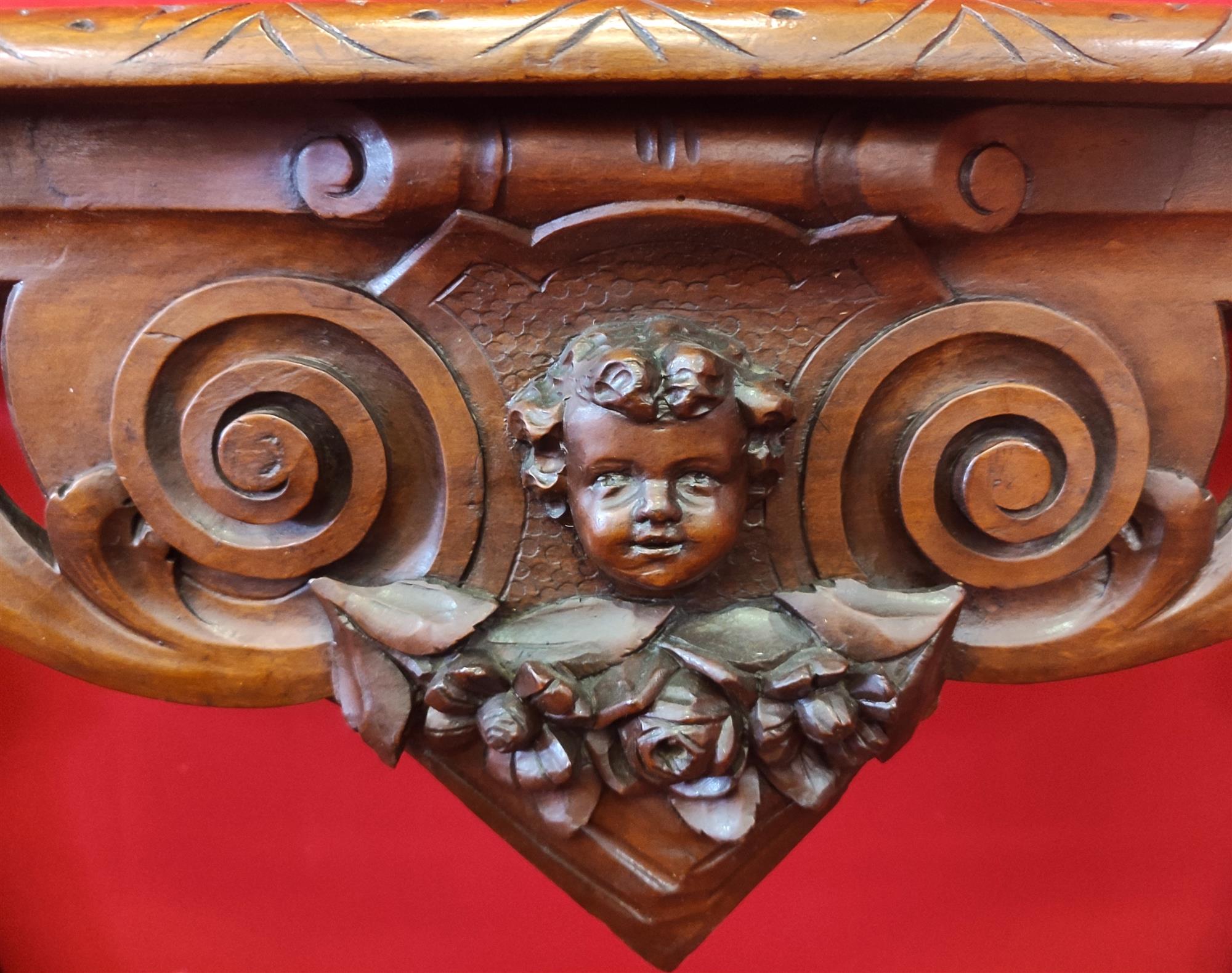 Italian console carved with children's faces