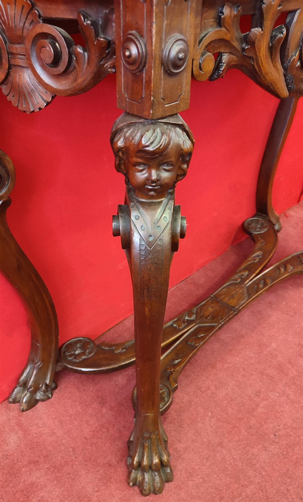 Italian console carved with children's faces