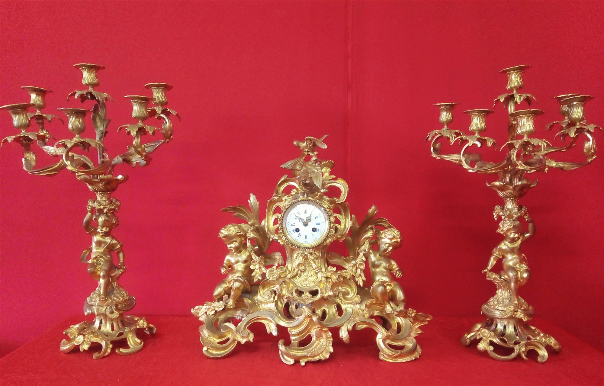 Orologio e Coppia di candelabri in bronzo dorato