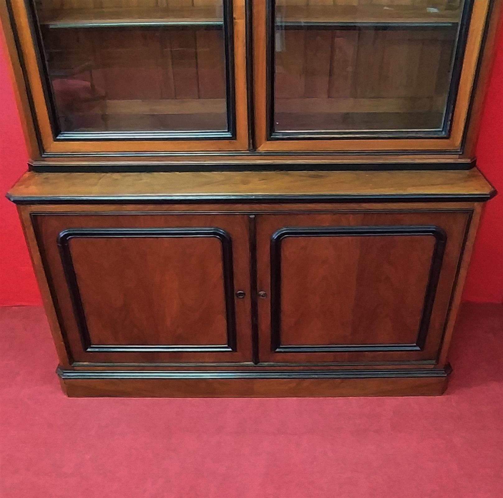 Walnut bookcase with black frames