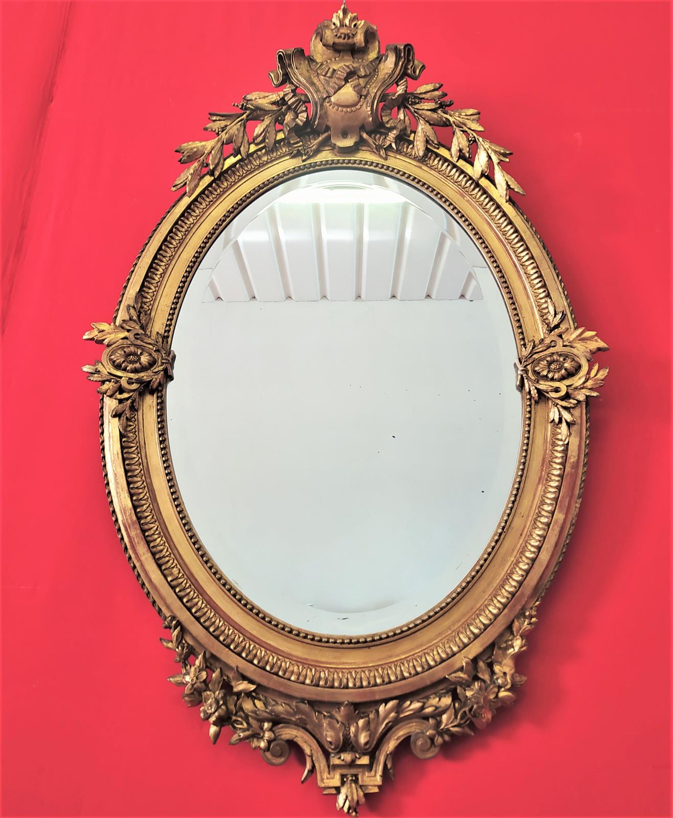 Golden oval mirror