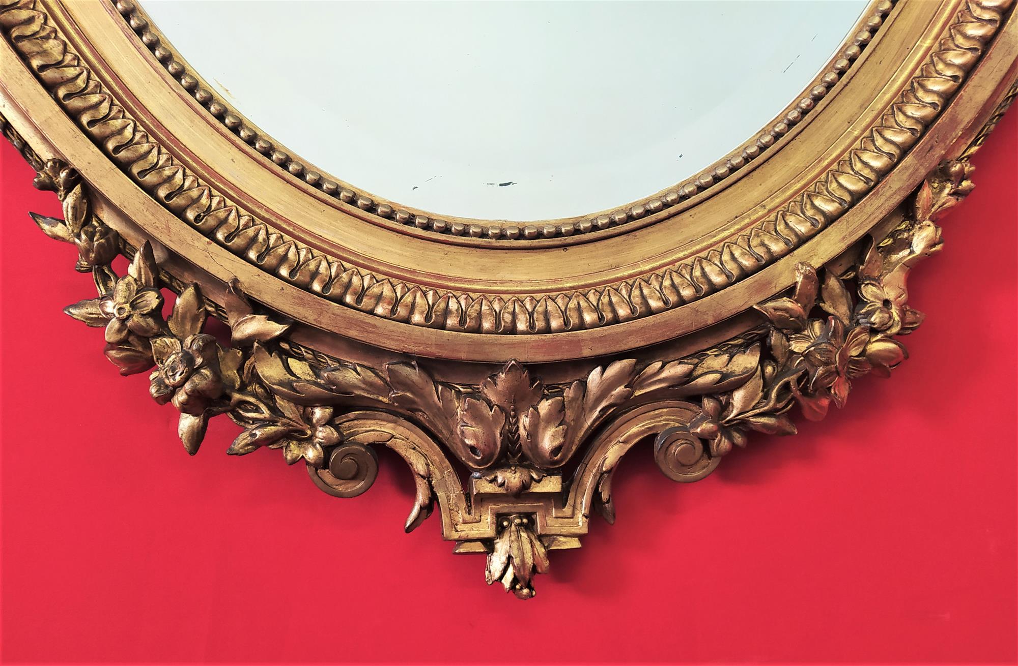 Golden oval mirror