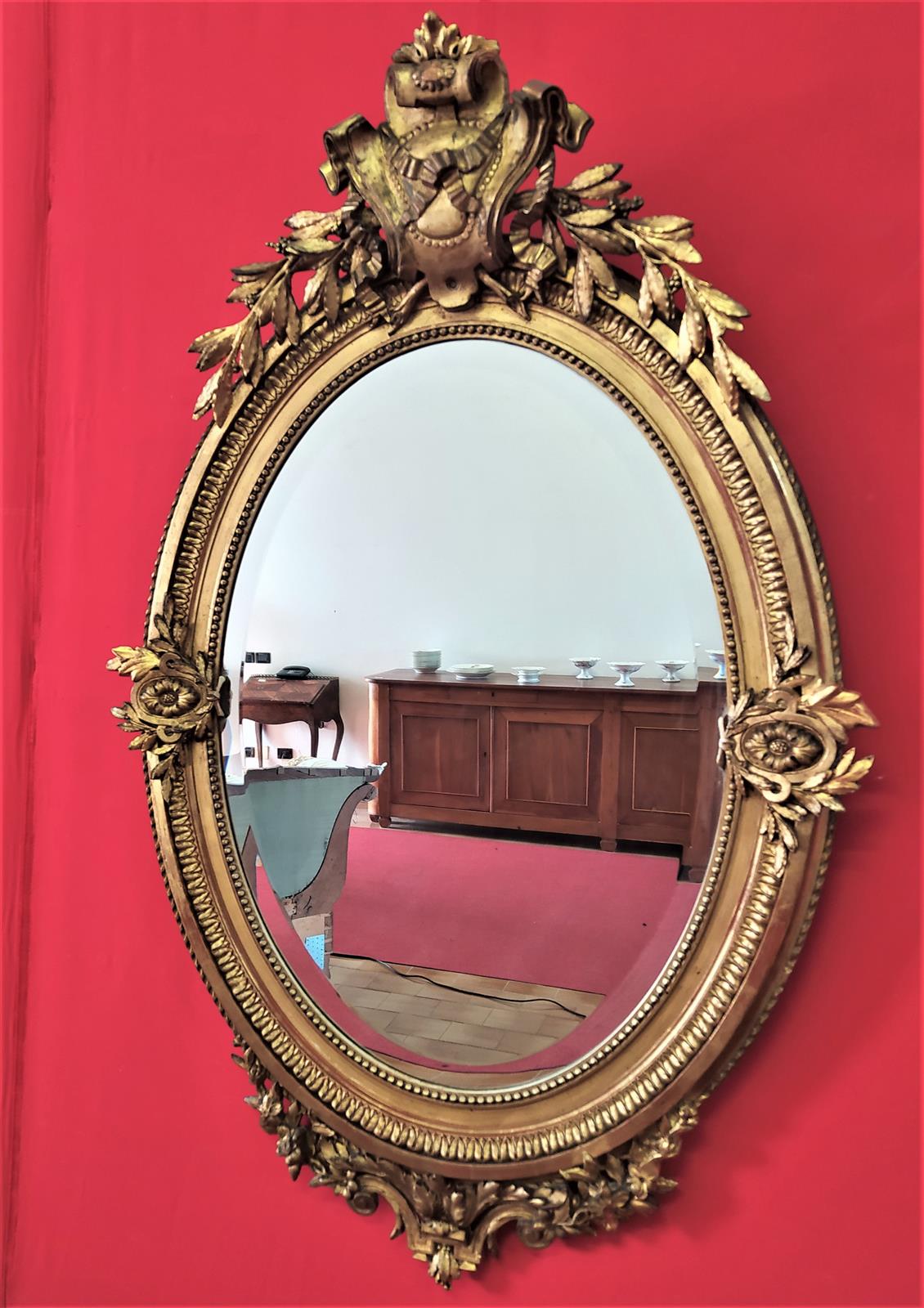 Golden oval mirror